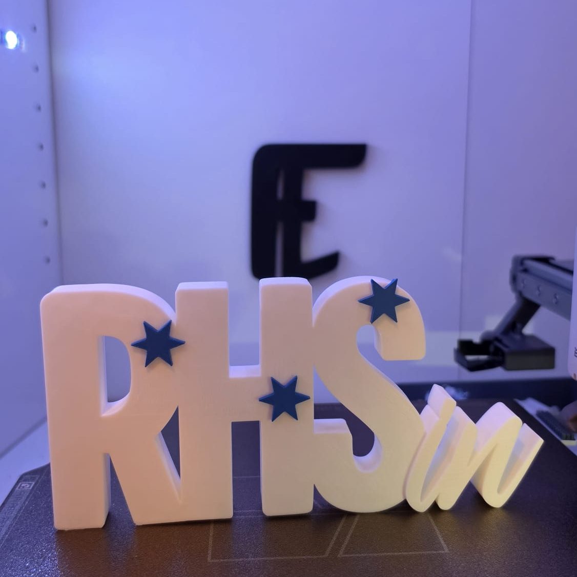 Bunte Buchstaben „RHS“ mit blauen Sternen - zur Beförderung